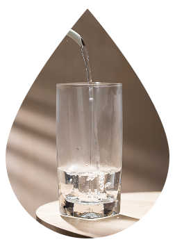 A glass of water being poured